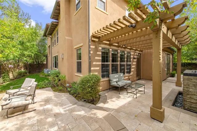 a view of a patio with table and chairs and potted plants