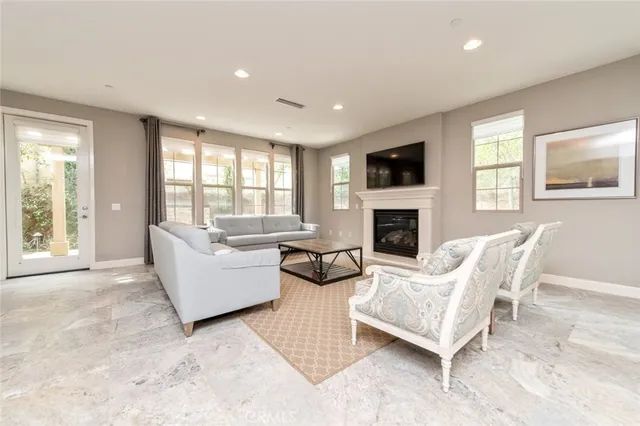 a living room with furniture fireplace and flat screen tv