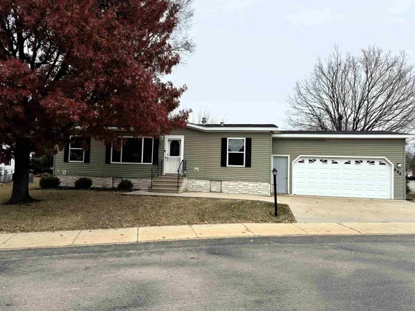 a view of a house with a patio and a yard