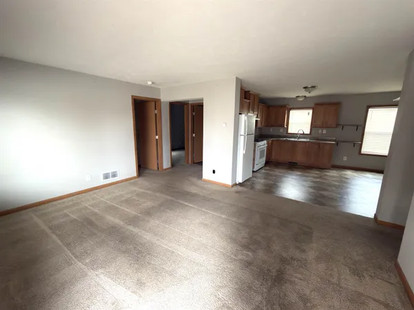 an empty room with windows and entrance