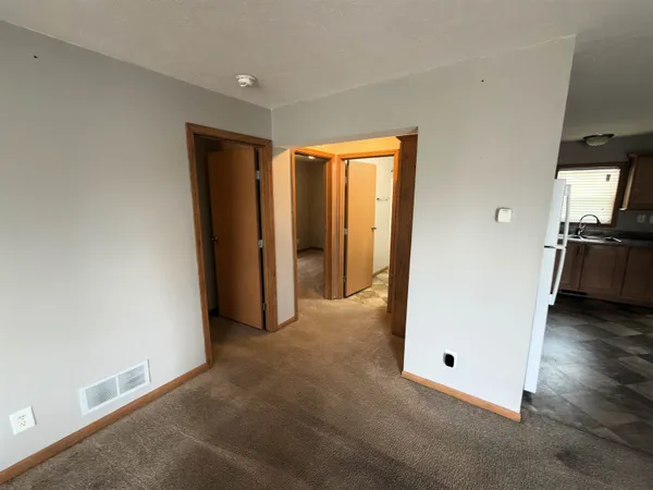 an empty room with wooden floor and closet