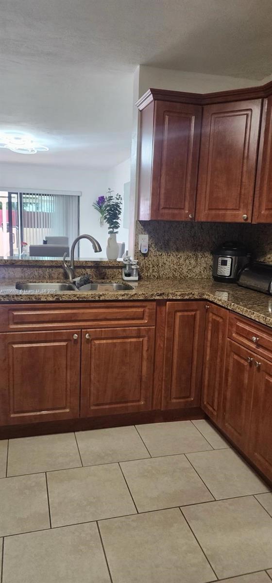 13208 Southwest 10th Lane Miami, FL 33184 - Photo 5 of 10 a kitchen with a sink a microwave and cabinets