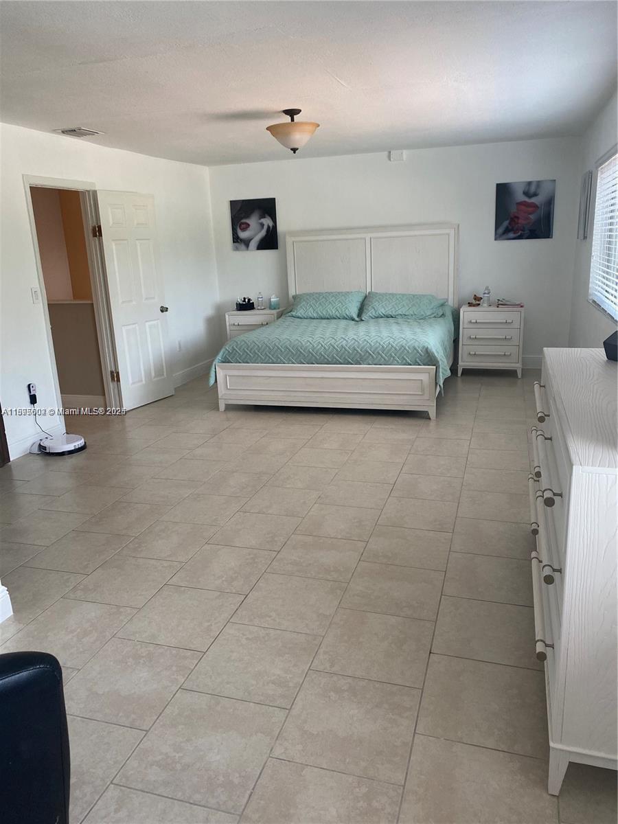 13208 Southwest 10th Lane Miami, FL 33184 - Photo 8 of 10 a en suite bathroom with a double vanity sink toilet and mirror