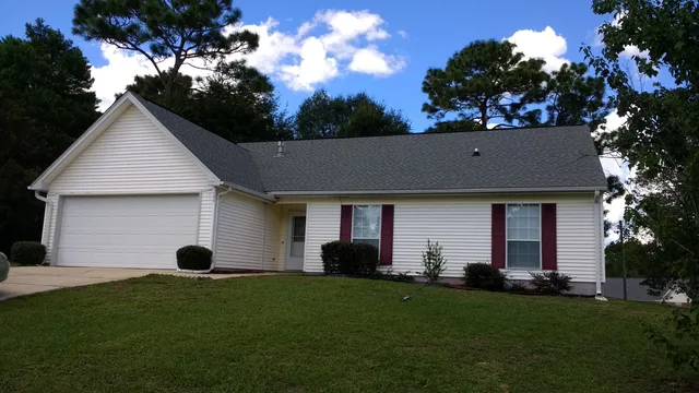 a view of a house with backyard and garden