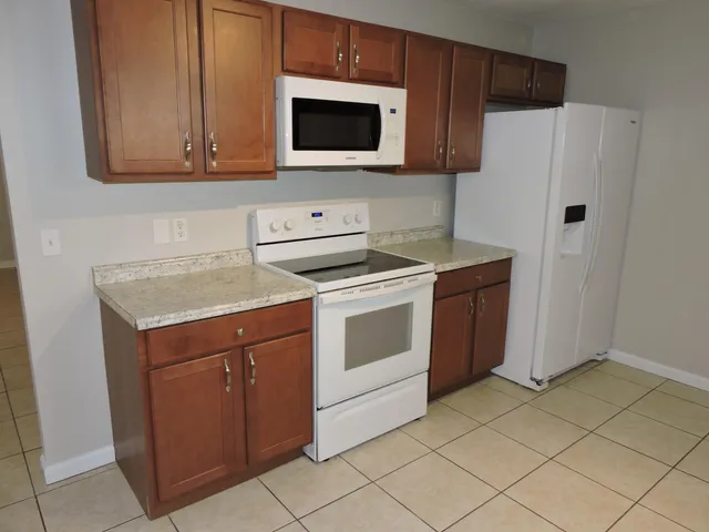 a kitchen with stainless steel appliances granite countertop a stove a microwave and a refrigerator