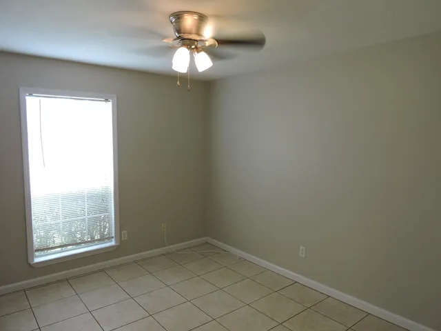 a view of bathroom with a shower and a mirror
