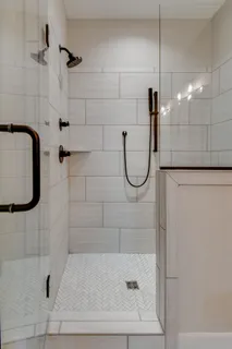 a bathroom with a glass shower door