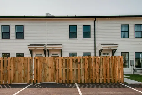 a view of a house with wooden fence
