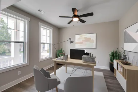a view of a livingroom with workspace and a window