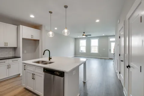 a kitchen with a sink chandelier and stove