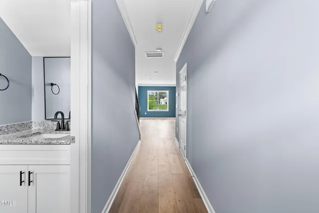 a kitchen with stainless steel appliances kitchen island a refrigerator sink and cabinets