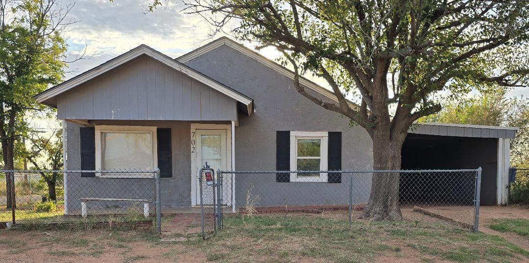 702 North Ave O Lamesa, TX 79331 - Photo 1 of 12 a front view of a house with garden