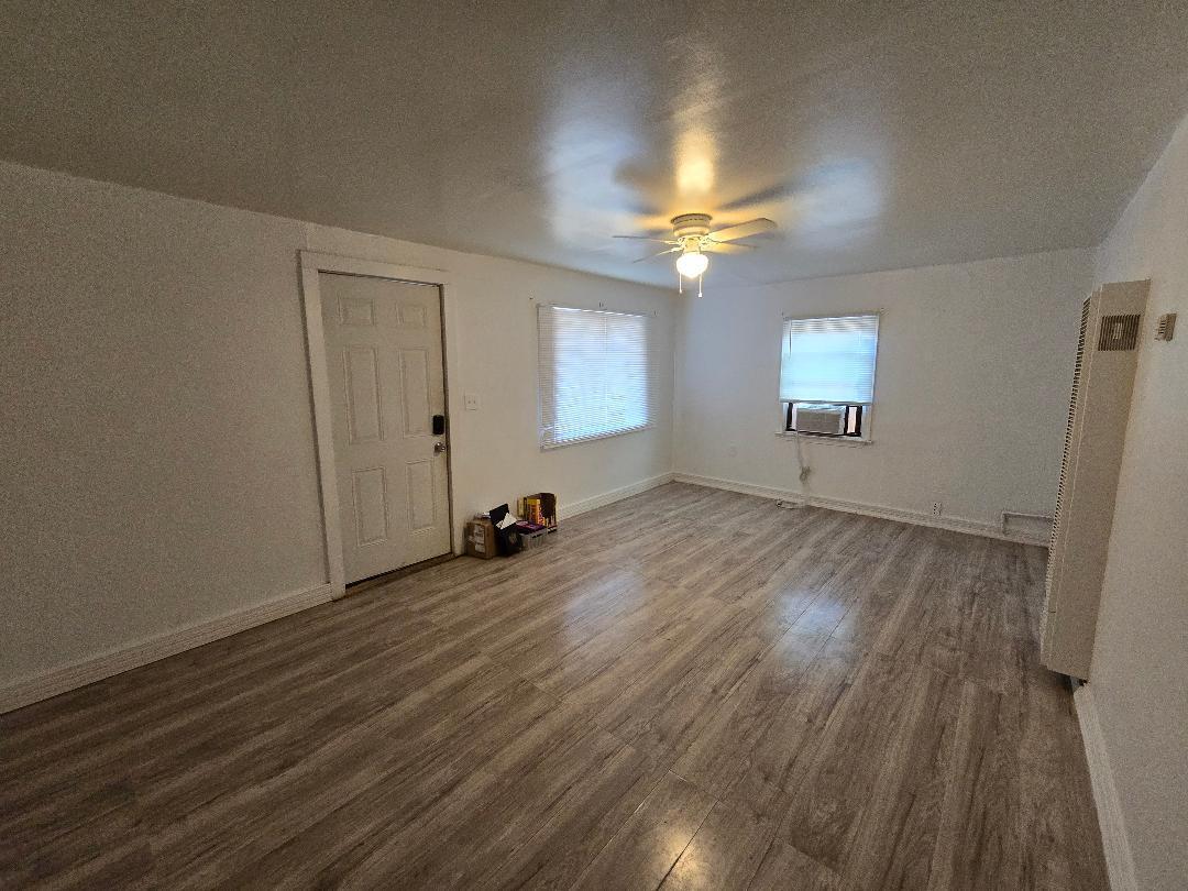 702 North Ave O Lamesa, TX 79331 - Photo 2 of 12 wooden floor in an empty room with a window