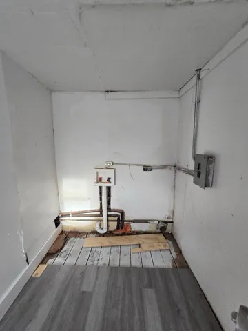 a view of a room with wooden floor