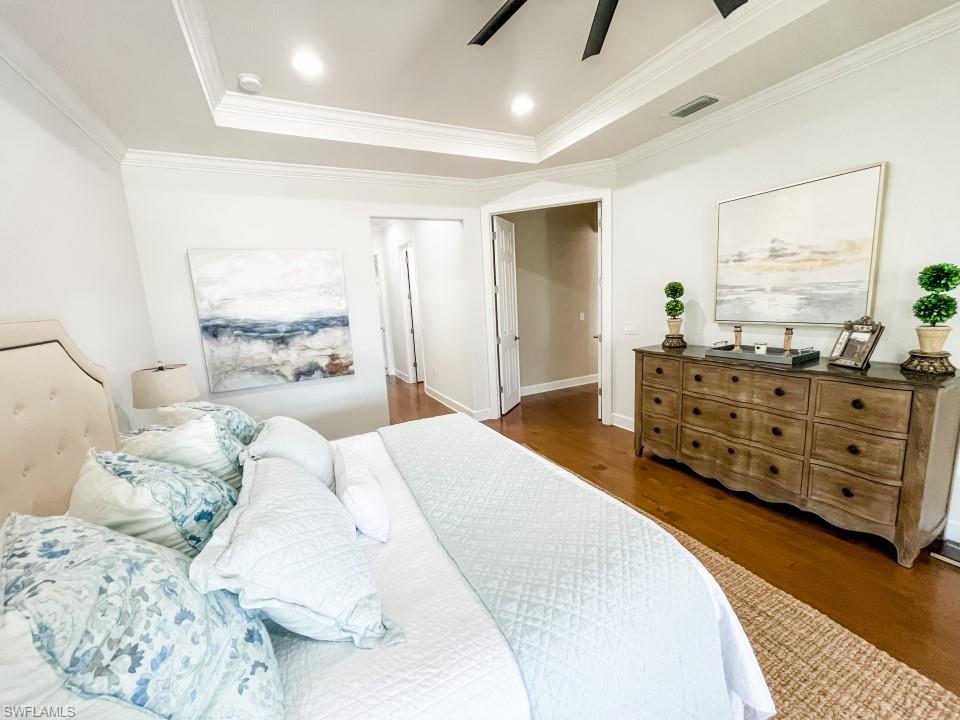 16163 Cartwright Lane Naples, FL 34110 - Photo 15 of 35 a bed room with a bed and a dresser