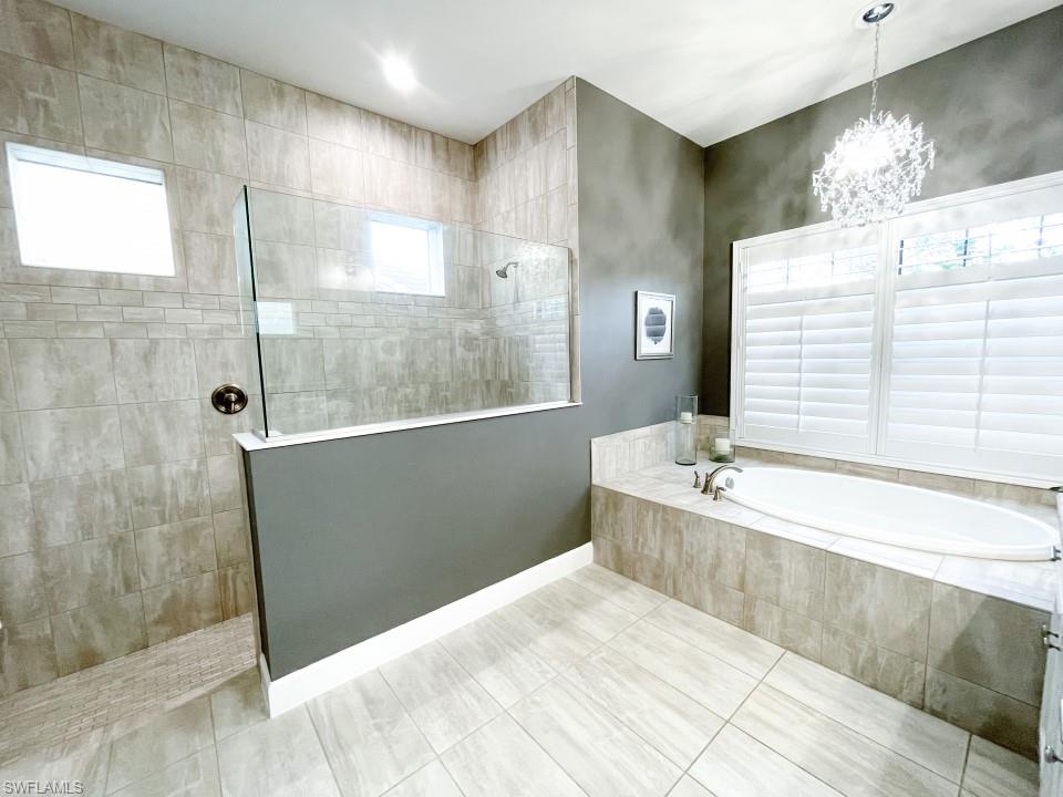 16163 Cartwright Lane Naples, FL 34110 - Photo 17 of 35 a bathroom with a bathtub and a sink