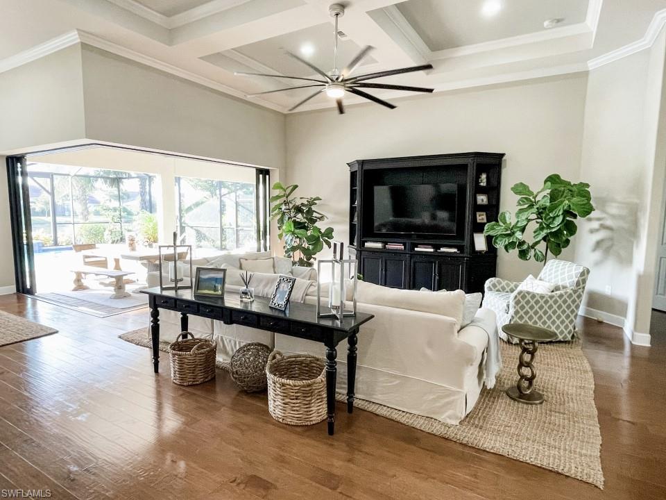 16163 Cartwright Lane Naples, FL 34110 - Photo 23 of 35 a living room with furniture a flat screen tv and a large window