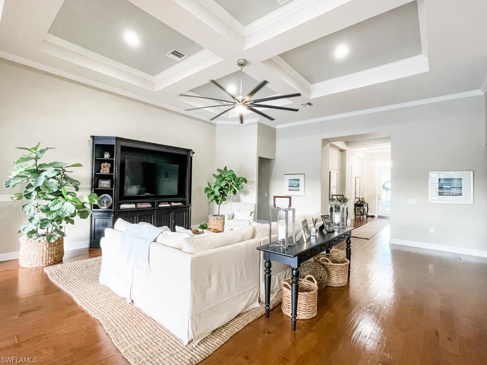 16163 Cartwright Lane Naples, FL 34110 - Photo 9 of 35 a living room with furniture a fireplace and a flat screen tv