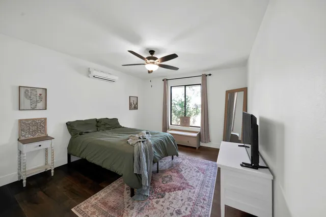a living room with furniture a flat screen tv and a window