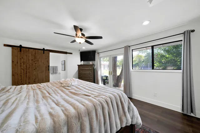 a bedroom with a bed and a chandelier