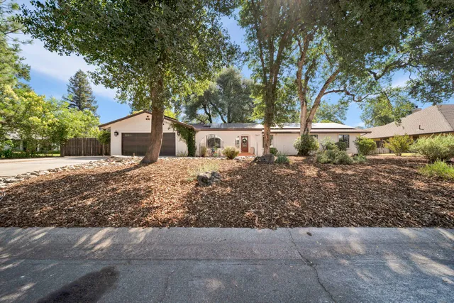 a view of house with tree in front of it