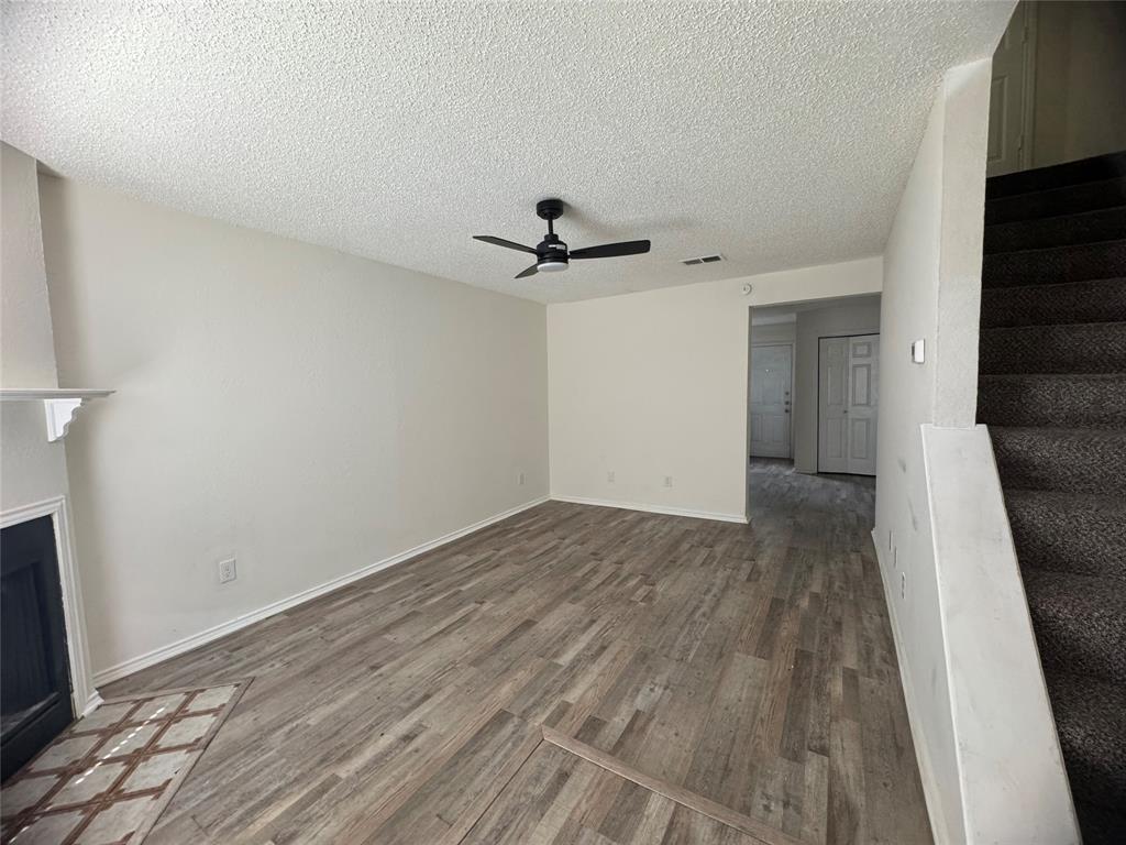 638 South Rogers Road Irving, TX 75060 - Photo 2 of 10 a view of a livingroom with wooden floor and a ceiling fan