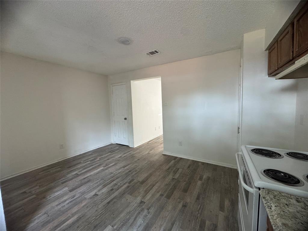 638 South Rogers Road Irving, TX 75060 - Photo 4 of 10 a view of an empty room with wooden floor