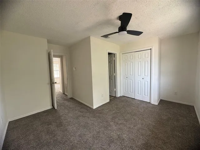 a view of empty room with ceiling fan