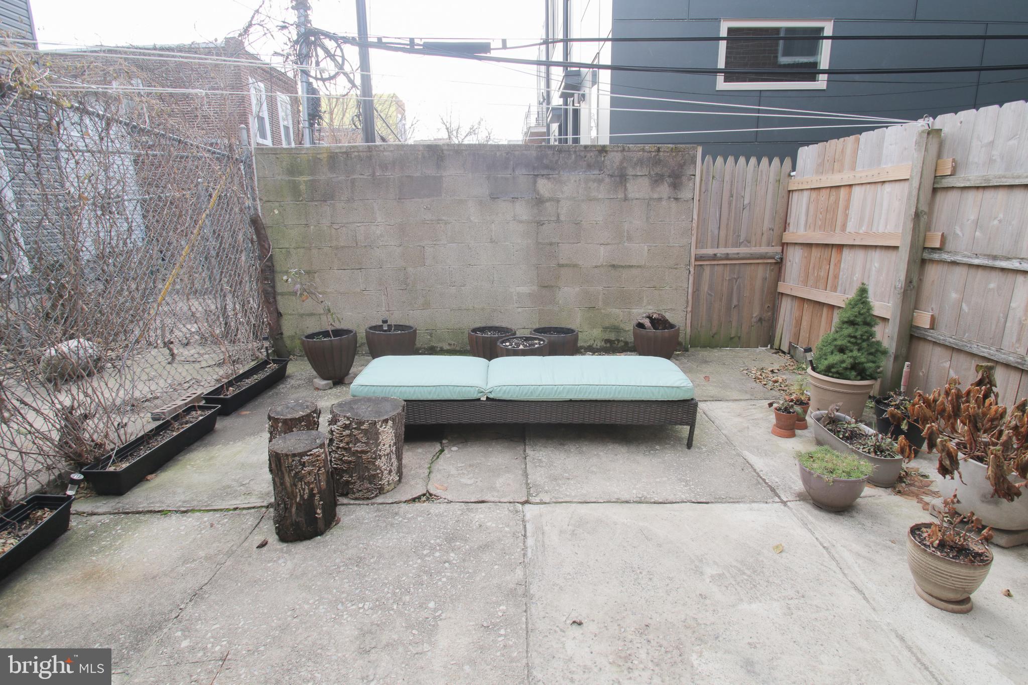 1708 Reed Street Philadelphia, PA 19146 - Photo 22 of 25 a view of a patio with a table and chairs and potted plants