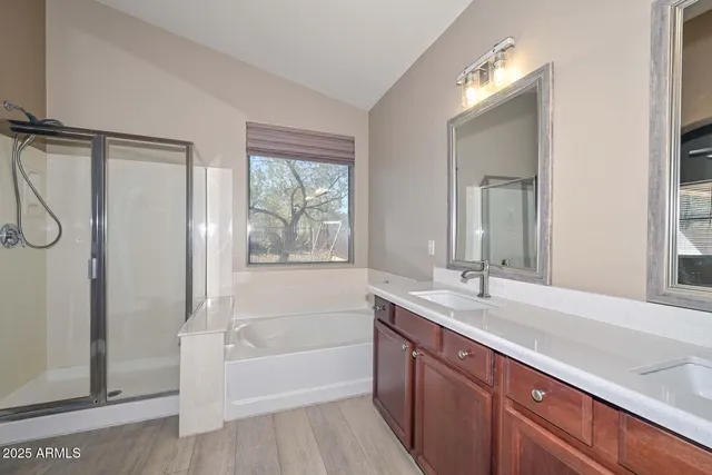 a bathroom with a tub sink and mirror