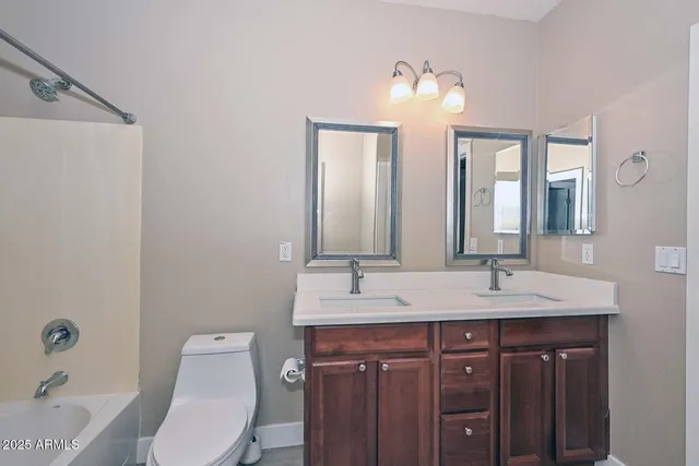 a bathroom with a double vanity sink and a mirror