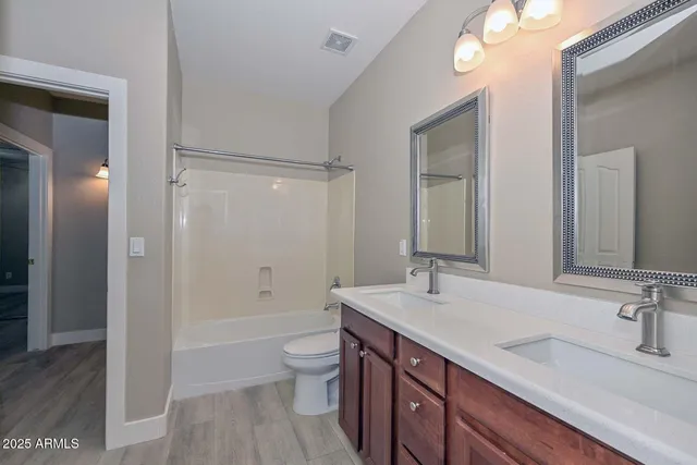 a bathroom with a sink double vanity granite tub and shower