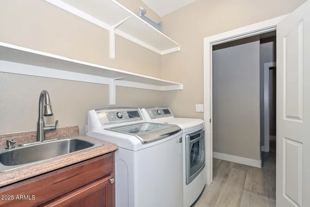 a kitchen with a sink and a stove top oven