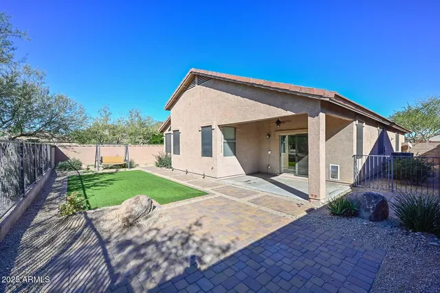 a view of a house with backyard and trees