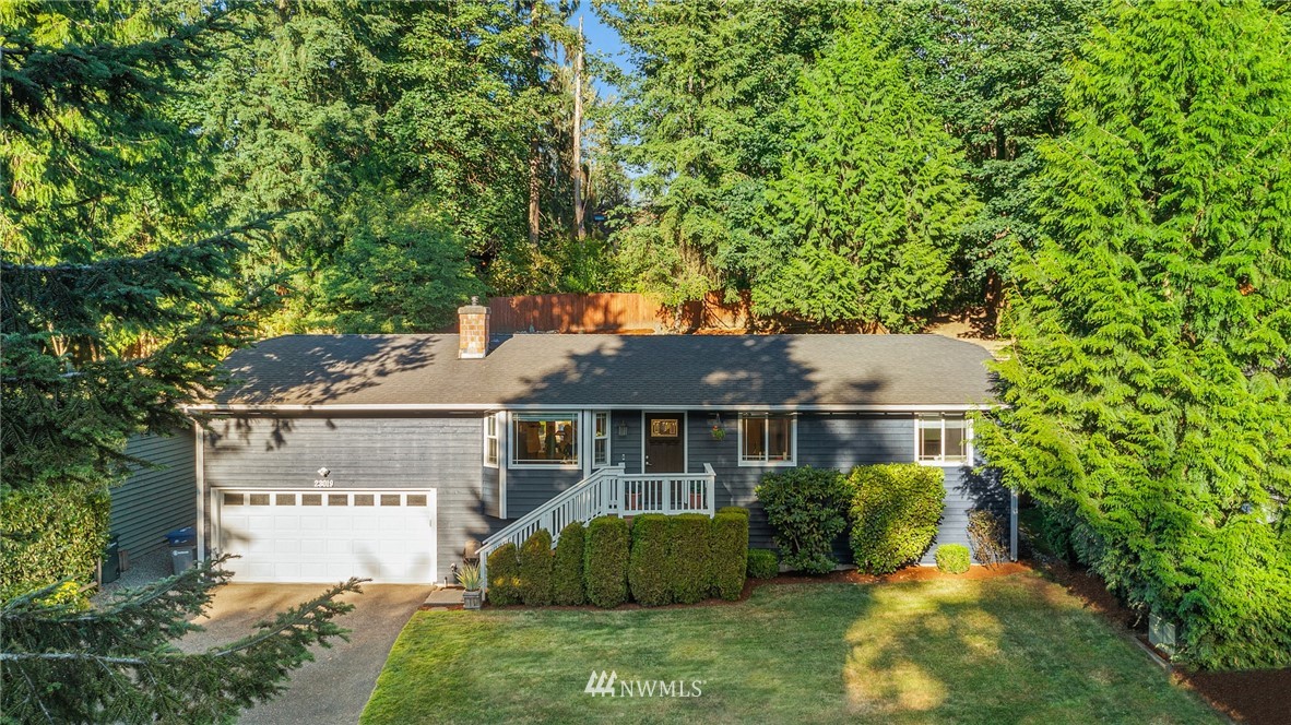23019 19th Drive Southeast Bothell, WA 98021 - Photo 1 of 28 a front view of a house with a garden