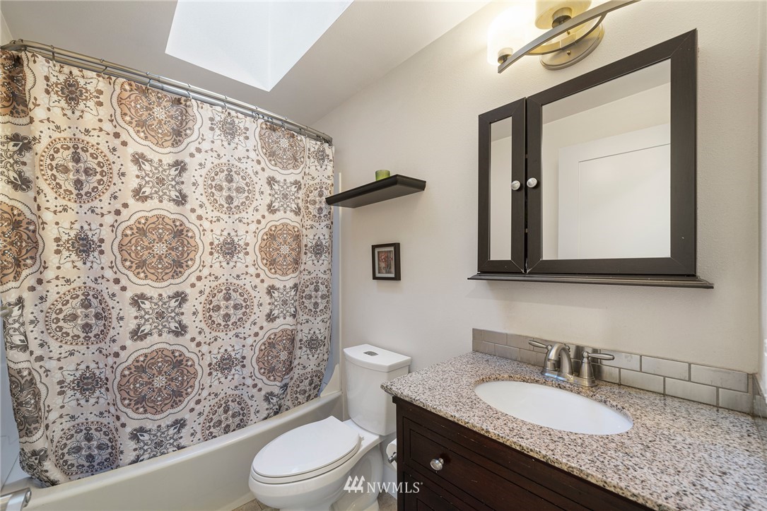 23019 19th Drive Southeast Bothell, WA 98021 - Photo 16 of 28 a bathroom with a granite countertop sink mirror vanity and toilet