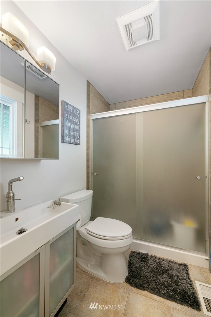 23019 19th Drive Southeast Bothell, WA 98021 - Photo 19 of 28 a bathroom with a sink a toilet and shower