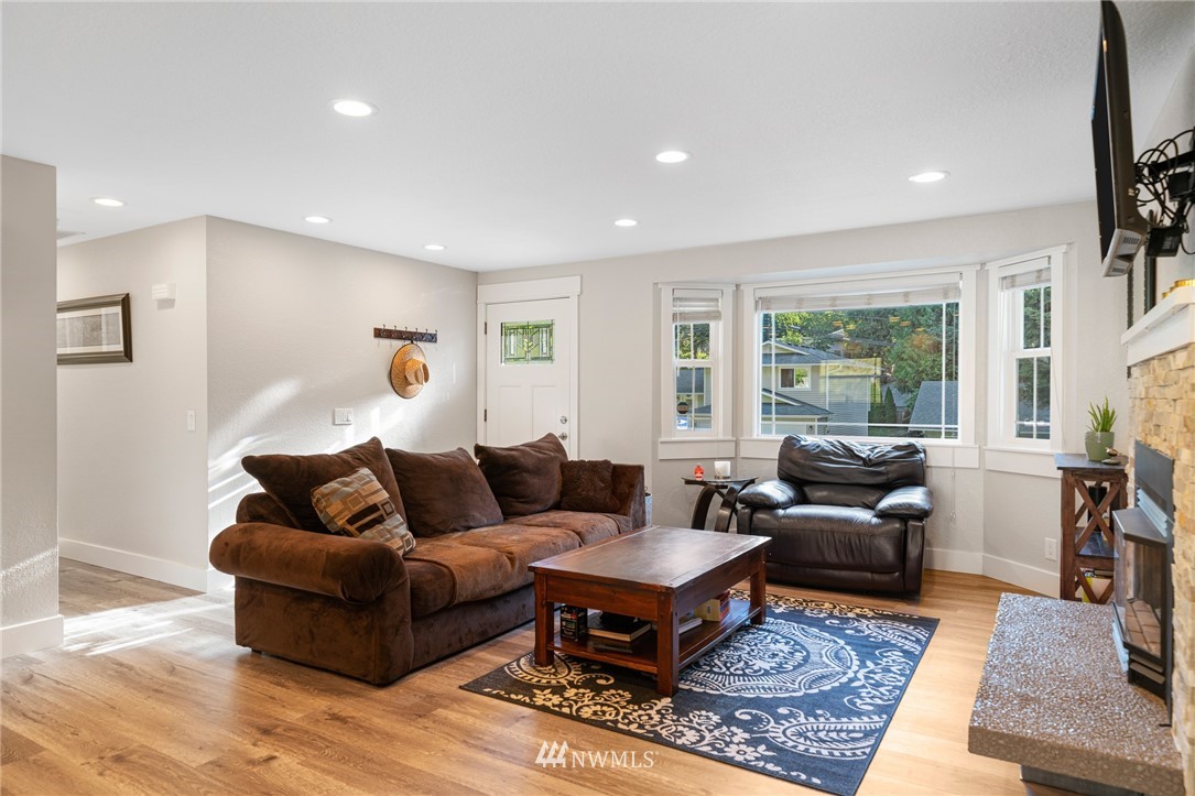 23019 19th Drive Southeast Bothell, WA 98021 - Photo 3 of 28 a living room with furniture a rug a lamp and a large window
