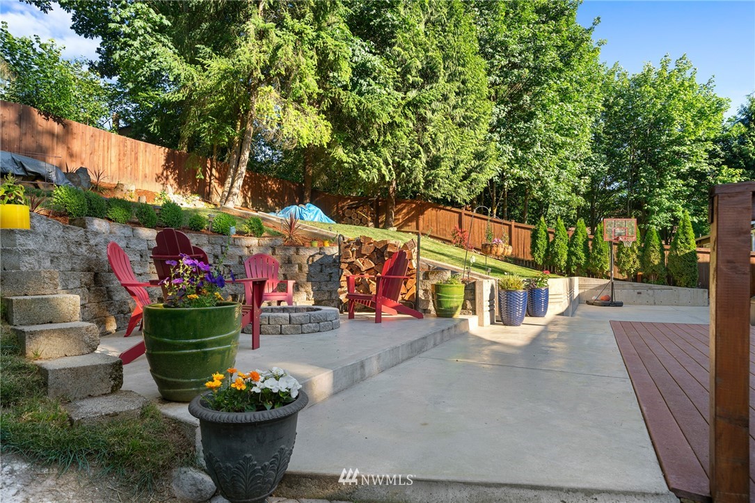 23019 19th Drive Southeast Bothell, WA 98021 - Photo 23 of 28 a view of a patio with table and chairs and potted plants