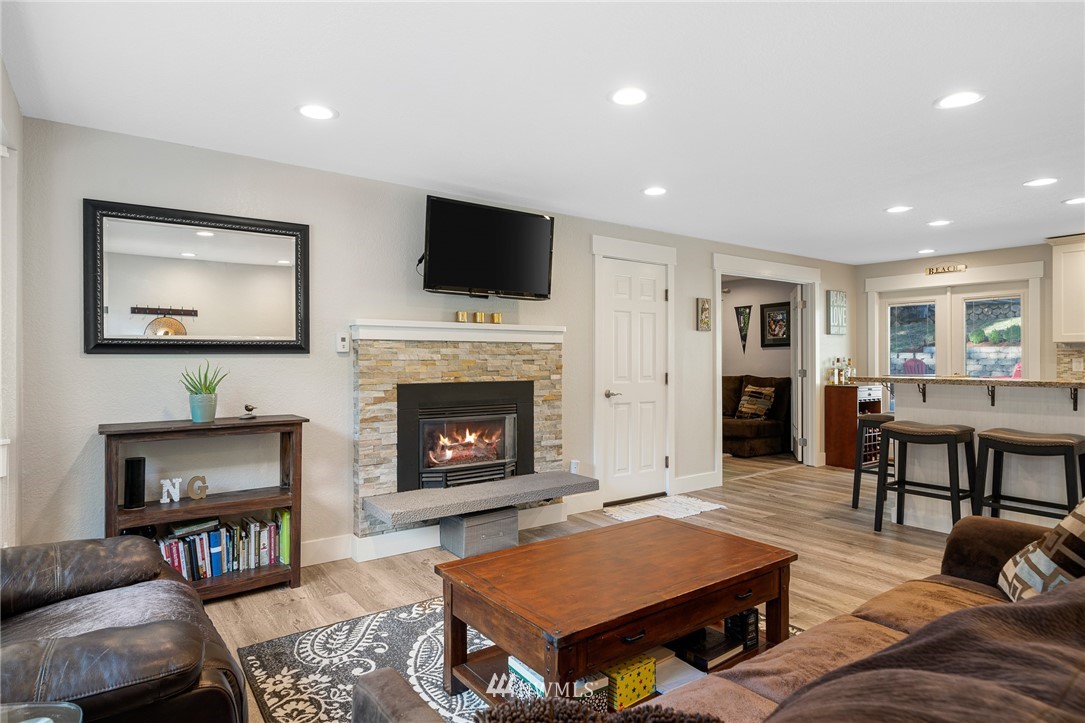 23019 19th Drive Southeast Bothell, WA 98021 - Photo 5 of 28 a living room with furniture a flat screen tv and a fireplace