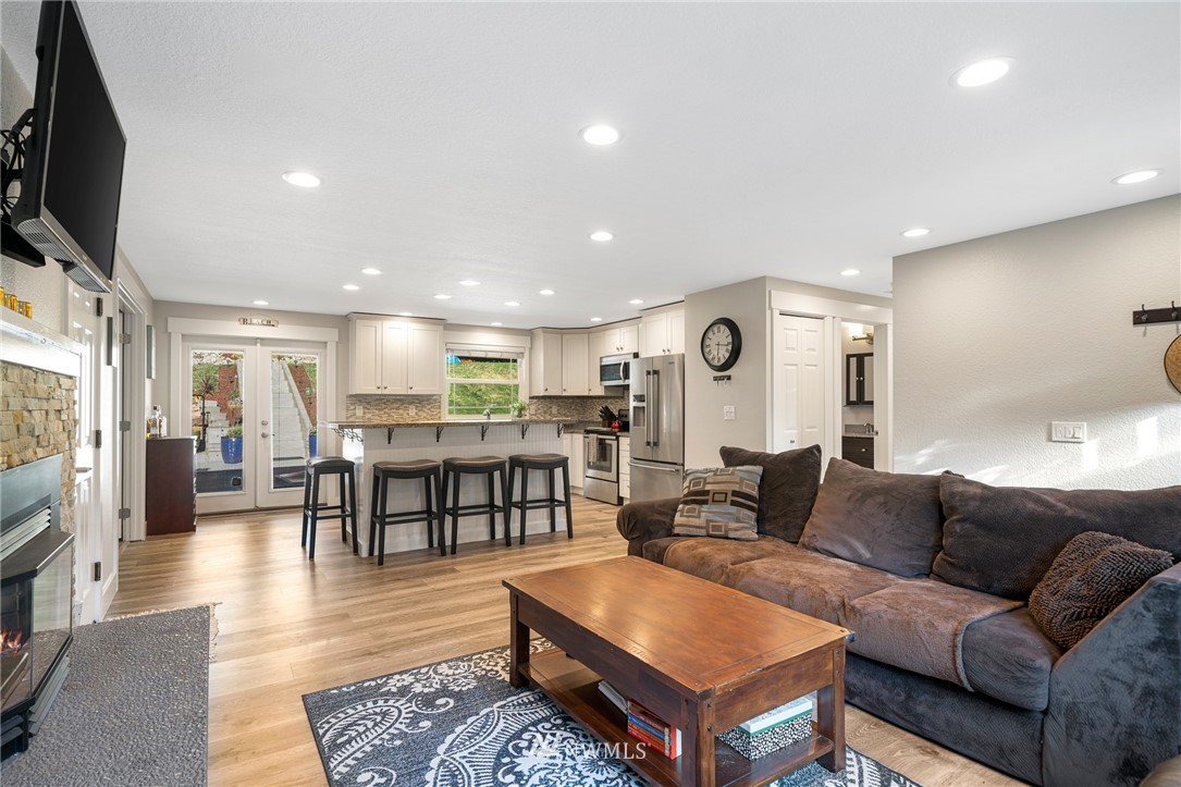 23019 19th Drive Southeast Bothell, WA 98021 - Photo 6 of 28 a living room with furniture a flat screen tv and a table