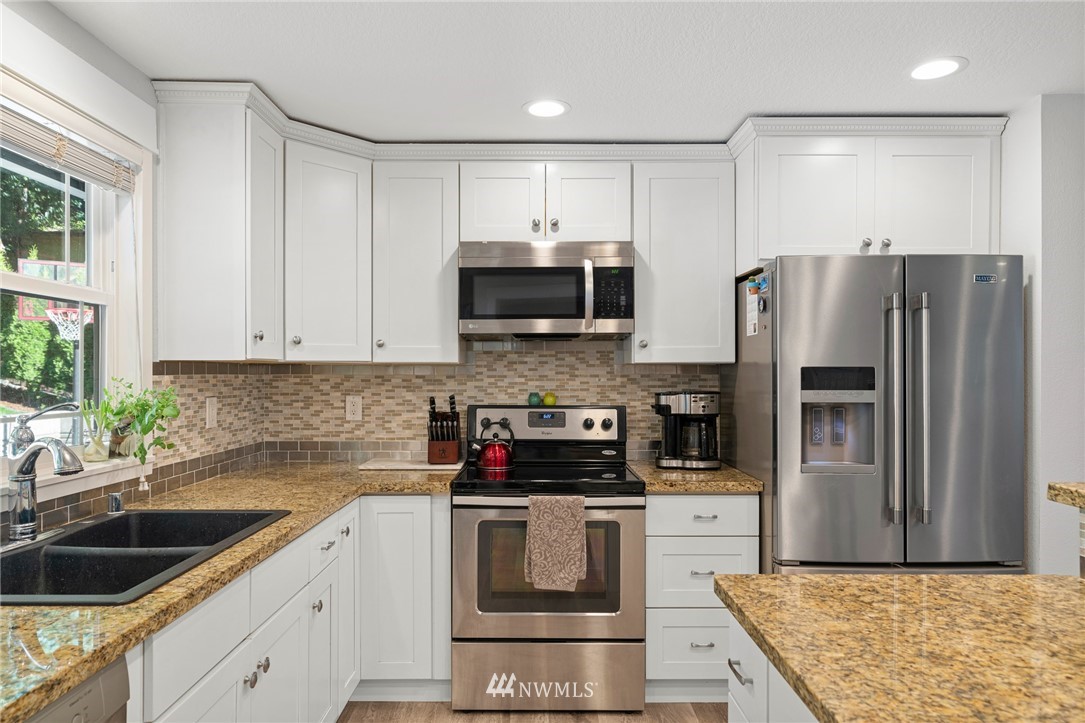 23019 19th Drive Southeast Bothell, WA 98021 - Photo 10 of 28 a kitchen with a sink and stainless steel appliances