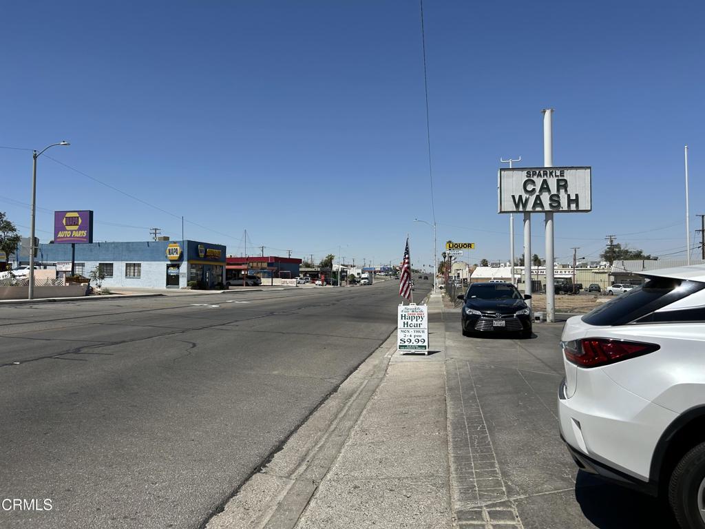 1401 Main Street Barstow, CA 92311 - Photo 26 of 66 a view of a city street with couple of cars parked on road