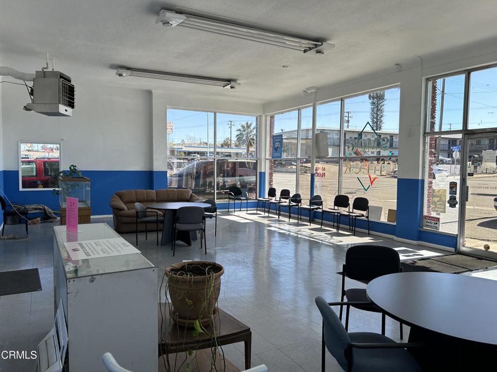 1401 Main Street Barstow, CA 92311 - Photo 64 of 66 a kitchen with a table chairs stove and cabinets