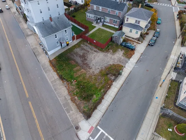 an aerial view of a house with a yard