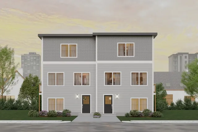 a front view of a building with a yard