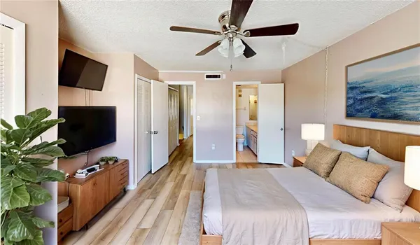 a bedroom with a bed and a potted plant