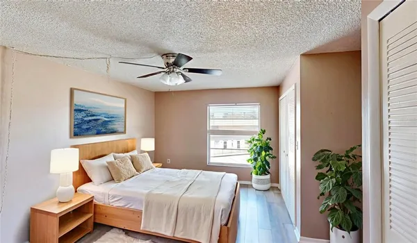 a view of hallway with wooden floor and a ceiling fan