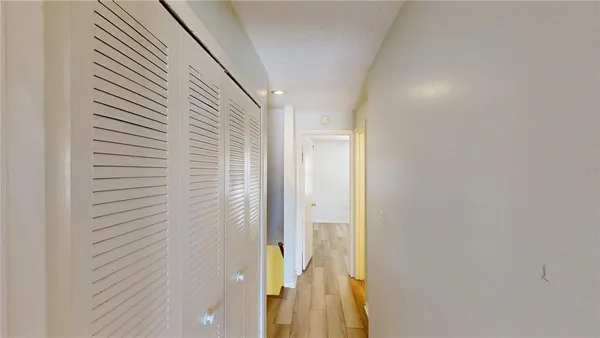 a bedroom with a large bed and a potted plant