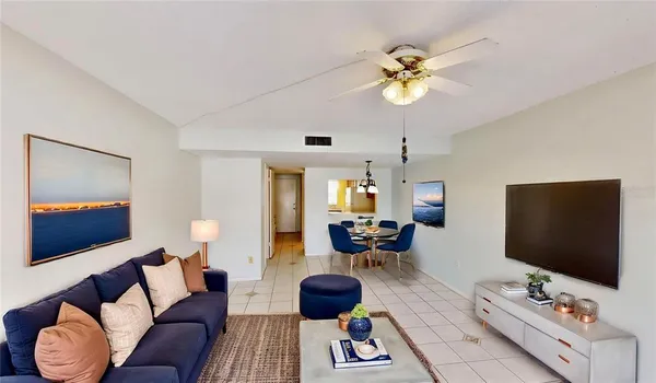 a view of a livingroom with a ceiling fan and window